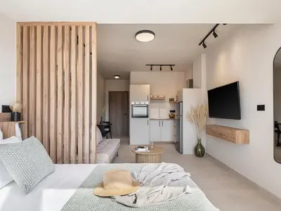 a bedroom with a bed with a hat on it at Aura Urban Living in the heart of Chania city in Chania Town