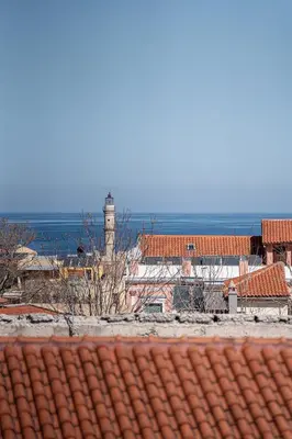 a view of a lighthouse from the roof of a building at Aura Urban Living in the heart of Chania city in Chania Town