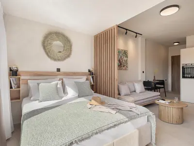 a bedroom with a large bed and a living room at Aura Urban Living in the heart of Chania city in Chania Town