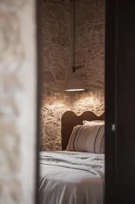 a view of a bedroom with a bed and a lamp at Corte Interna, free heated pool in Kalivianí