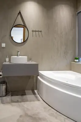 a bathroom with a tub and a sink and a mirror at Anele Luxury Suites - Roof Top Jacuzzi in Chania Town