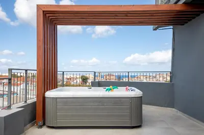 a hot tub on a balcony with a view at Anele Luxury Suites - Roof Top Jacuzzi in Chania Town