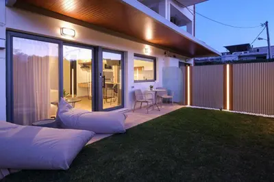 a backyard with pillows on the lawn at night at Studio Verde Glaros w. Outdoors, near the Beach in Kato Daratso