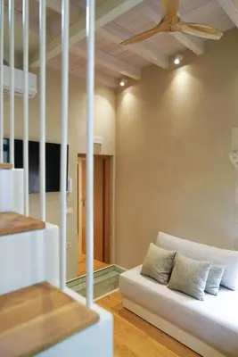 a living room with a couch and a ceiling at Mystiko Maisonette with Hot Tub - Chania Old Town in Chania Town