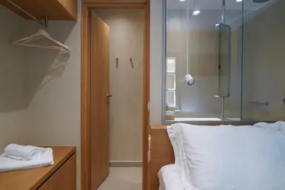 a bedroom with a bed and a glass shower at Mystiko Maisonette with Hot Tub - Chania Old Town in Chania Town