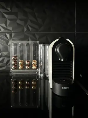 a black and white photo of a toaster with donuts at Serenity Living in Palaiochóra