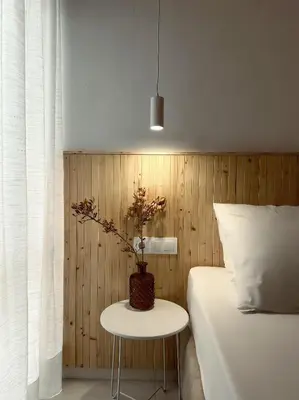 a bedroom with a bed and a table with a plant at Serenity Living in Palaiochóra