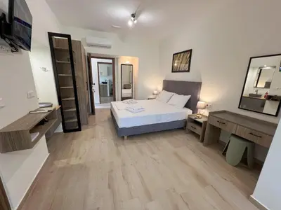 a bedroom with a bed and a desk and a mirror at AZOGIRE Resort in Azoyirés