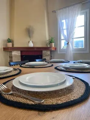 a table with plates and utensils on top of it at Olives Villa in Anopoli Sfakion