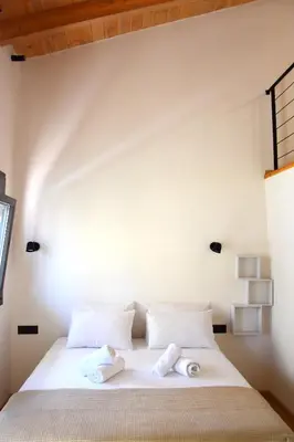 a bedroom with a bed with two towels on it at Gkerola house - small cozy house close to Chania town center in Chania Town