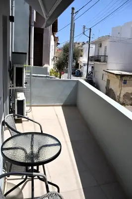 a patio with two chairs and a table on a balcony at Gkerola house - small cozy house close to Chania town center in Chania Town