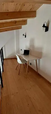 a laptop computer sitting on a desk in a room at Gkerola house - small cozy house close to Chania town center in Chania Town