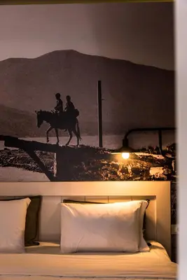 a bed with a picture of two people riding a horse at Elia Daliani in Chania Town
