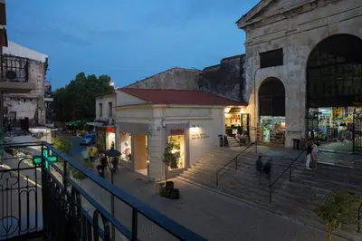 a group of people walking on a street next to a building at Elia Daliani in Chania Town