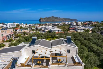 a building with a view of a city and the ocean at Sun Flower Villas in Agia Marina Nea Kydonias