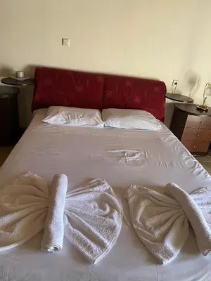 a bed with white sheets and towels on it at Evgoro in Chania Town