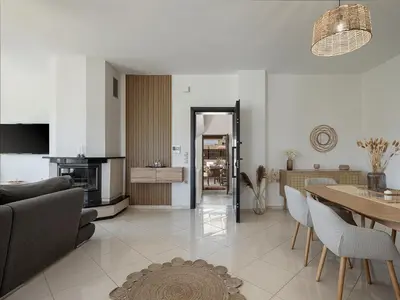 a living room with a table and a dining room at Sol Luxury Apartment - close to the beach with a private heated mini pool in Chania Town