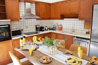 a kitchen with a table with food on it at NAMA -Central vacation rental with free parking only 900m far from Venetian Port and beach! in Chania Town
