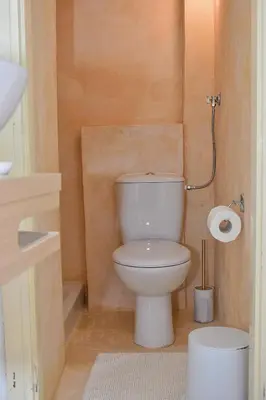 a bathroom with a toilet and a toilet paper roll at Κρητικό παραδοσιακό διαμέρισμα! in Chania Town