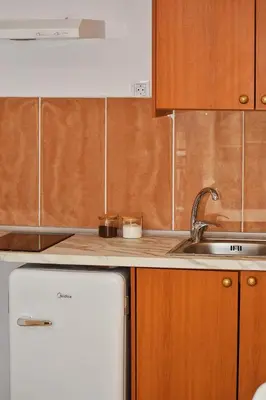 a kitchen with a white refrigerator and a sink at Κρητικό παραδοσιακό διαμέρισμα! in Chania Town