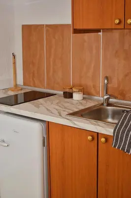 a kitchen with a sink and a refrigerator at Κρητικό παραδοσιακό διαμέρισμα! in Chania Town