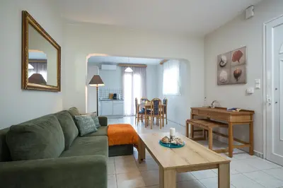 a living room with a couch and a table at Zoe's Place - 1 BD Beachfront Apartment in Kissamos