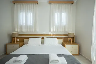 a bedroom with a large bed with two towels on it at Zoe's Place - 1 BD Beachfront Apartment in Kissamos