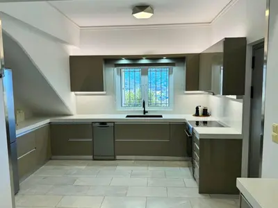 a large kitchen with a sink and a window at Villa Raks in Kántanos