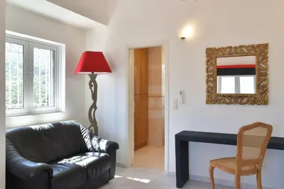a living room with a couch and a table and a mirror at Villa Raks in Kántanos