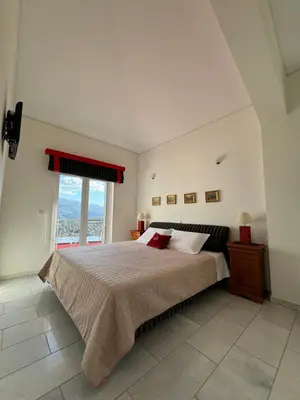 a bedroom with a large bed and a window at Villa Raks in Kántanos