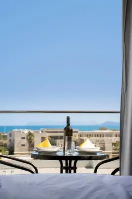 a bottle of wine sitting on a table on a balcony at Kolymvari Hills in Chania Town