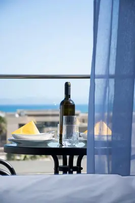 a table with a bottle of wine and a glass at Kolymvari Hills in Chania Town