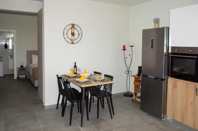 a kitchen with a table with chairs and a refrigerator at Kolymvari Hills in Chania Town
