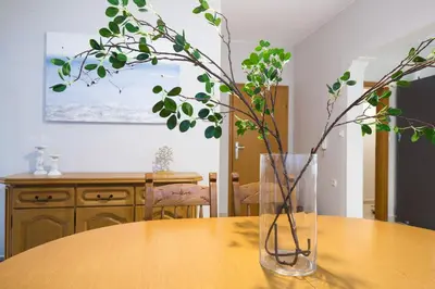 a vase sitting on a table with a plant in it at Zoe's Place - 2 BD Beachfront Apartment in Kissamos
