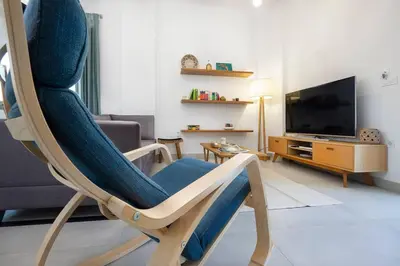 a living room with a chair and a television at Sea Apt - Akrotiri in Kounoupidhianá