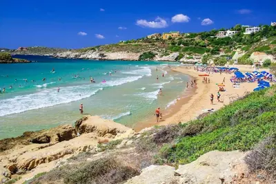 a group of people on a beach in the water at Olive Apt - Akrotiri in Kounoupidhianá