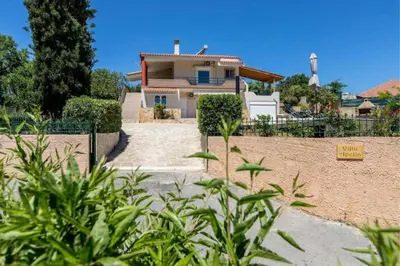 a house with a fence in front of it at VILLA APELLA - PRIVATE HEATED POOL in Nohia