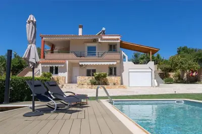 a villa with a swimming pool and a house at VILLA APELLA - PRIVATE HEATED POOL in Nohia