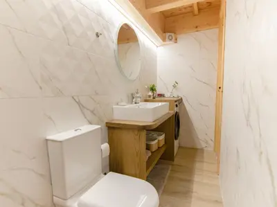 a bathroom with a white toilet and a sink at House Of Ntounias ΙΙ in Dhrakóna
