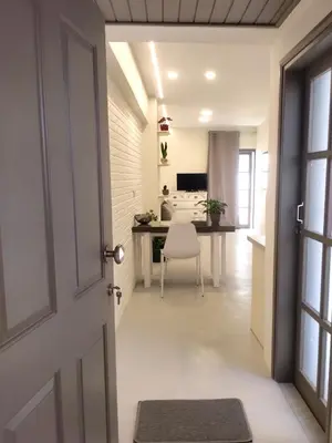 a hallway with a door leading to a living room at Vabis Koum - Kapi in Chania Town