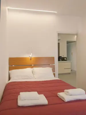 a bedroom with a bed with two towels on it at Vabis Koum - Kapi in Chania Town
