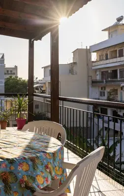 a table and chairs on a balcony with a view at Big spacious apartment in the heart of the city! in Chania Town