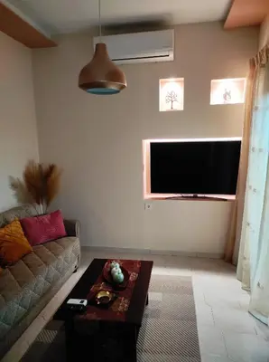 a living room with a couch and a flat screen tv at TziApartment in downtown Chania in Chania Town