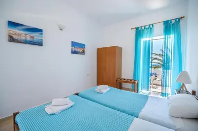 a bedroom with two beds and a window at MYLOS (6) in Chania Town