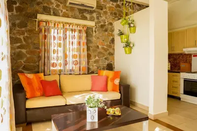 a living room with a couch with colorful pillows at Seaview villa Amphitriti with Private Pool, 20 min from Elafonissi beach in Chania Town