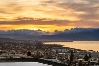 a view of a city with a sunset in the background at Sunset Apartment in Platanias in Plataniás