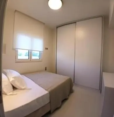 a bedroom with a bed and a large closet at White Dome Apartment I in Souda