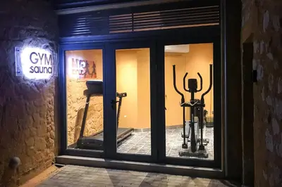a window of a gym with two gym swiss machines at Eleni's Serenity - Discovering Sapphire Harmonies in Ravdhoúkha