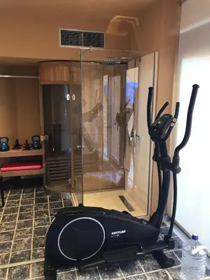 a room with a shower with a treadmill next to it at Eleni's Serenity - Discovering Sapphire Harmonies in Ravdhoúkha