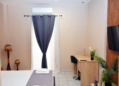 a room with a bed with a blue curtain at Relaxed Dream home in Chania Town